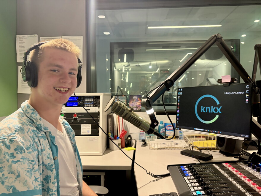 DJ Ross Gawthrop behind the microphone in the KNKX studios.