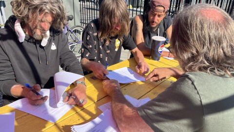 Elk Island Operations Manager Bernie Woodard, r, helps new Parker's Place Village residents fill out paperwork. Shown Aug. 4, 2026.