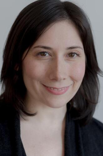 White woman with short, shoulder-length, black hair and wearing a black shirt. 