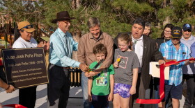 Albuquerque Mayor Tim Keller, alongside his children and Barelas community members cut the ribbon on the park's reopening