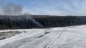 Smoke rises from the site of Tuesday morning's plane crash along the Tanana River west of Fairbanks