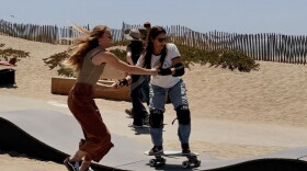 Two skate jam attendees try out the park's pump track feature