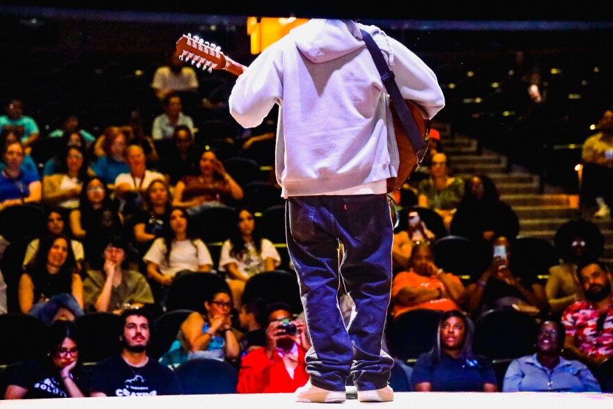 a student at the big thought summer showcase performs an original song