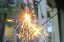 sparklers sparkle in front of US flag 