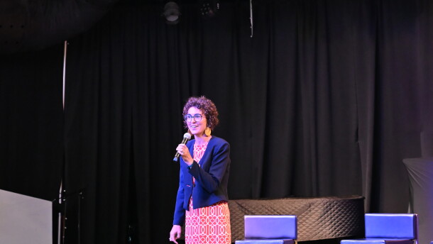 University of Tulsa professor of economics Clara Mattei stands on stage to speak to Tulsa residents during a forum organized by the Forum for Real Economic Emancipation.