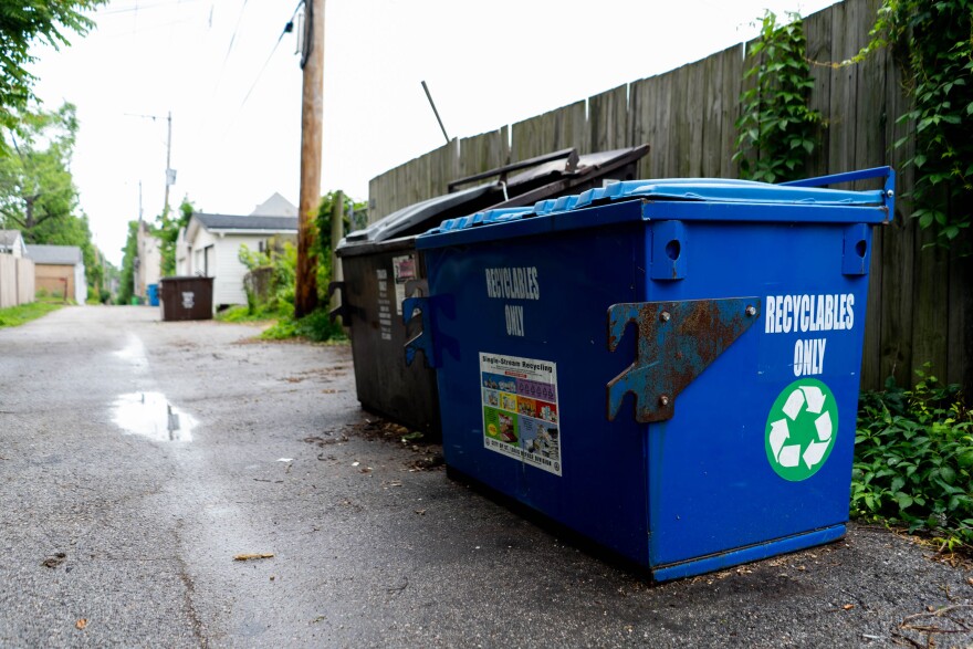 A blue recycling bin sits in an alleyway in south St. Louis