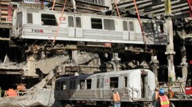 During recovery from the World Trade Center wreckage, Car 745 is swung over Car 143 by crane. (Peter Rinaldi/Shoreline Trolley Museum)