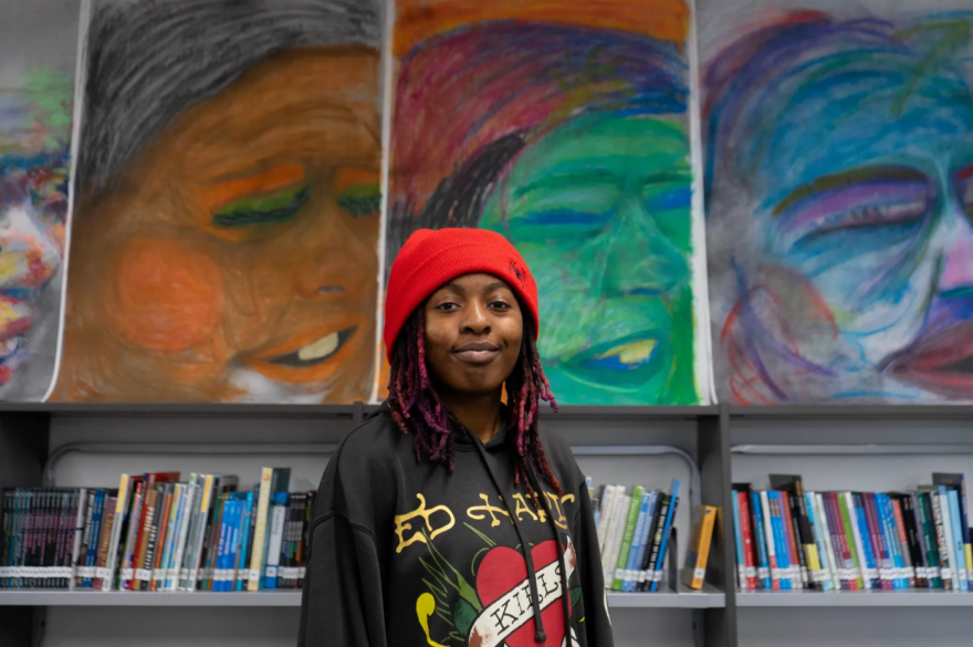 Dunbar High student Amber Tyler stands in front of a portrait she created that hangs in the school’s library on Feb. 6, 2026. The chalk pastel artwork was created through a partnership program at the Modern Art Museum of Fort Worth.