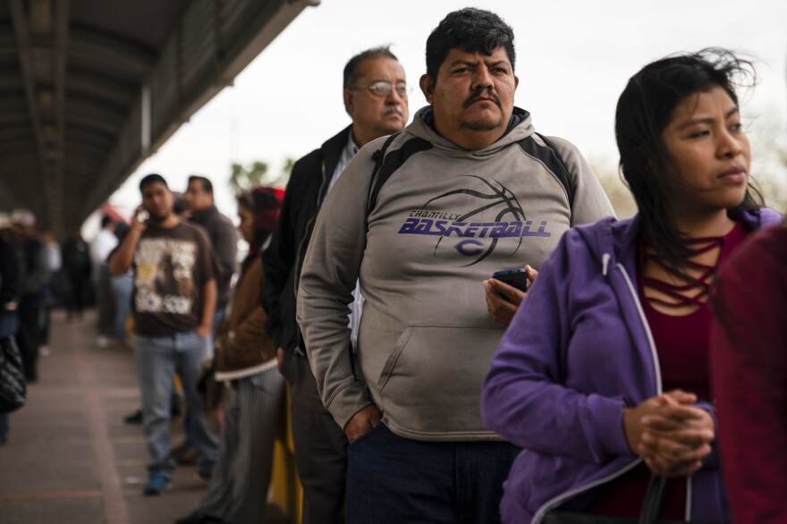 Marvin Sr. waits in line on the international bridge for his final immigration hearing. A judge denied his application for asylum that afternoon. Marvin remains in the Matamoros refugee camp with no good options left.