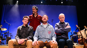Adam Gardner, Brian Rosenworcel, Ryan Miller and Luke Reynolds (L-R) of Guster pose on a bench on the Hoyt Sherman Place stage.