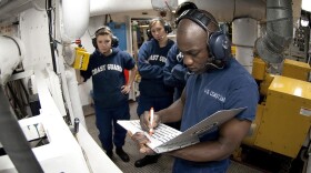 U.S. Coast Guard Academy Cadet Orlando Morel reviews a logbook in the generator room aboard the Coast Guard Cutter Eagle on June 23. Morel was 6 years old when he and his mother were rescued by the Coast Guard while leaving Haiti. Morel graduated Wednesday from the academy in New London, Conn.