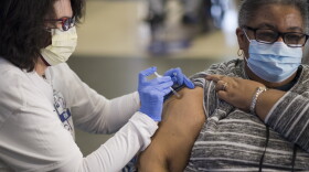 A patient is vaccinated at a Novant Health clinic at Spectrum Center on Feb. 13.