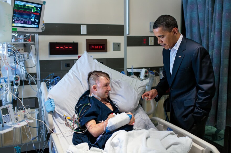 President Barack Obama greets after having routine physical exam and visiting wounded warriors at Bethesda Naval Hospital in Bethesda, MD., Feb. 28, 2010. (Courtesy of Little, Brown and Company/Pete Souza)