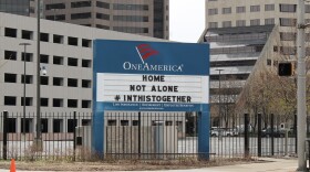 One America's signs in downtown Indianapolis usually display a pun. Since the governor's initial "Stay-At-Home" order, both have encouraged social distancing. It reads: "Home, not alone. #InThisTogether." (Lauren Chapman/IPB News)