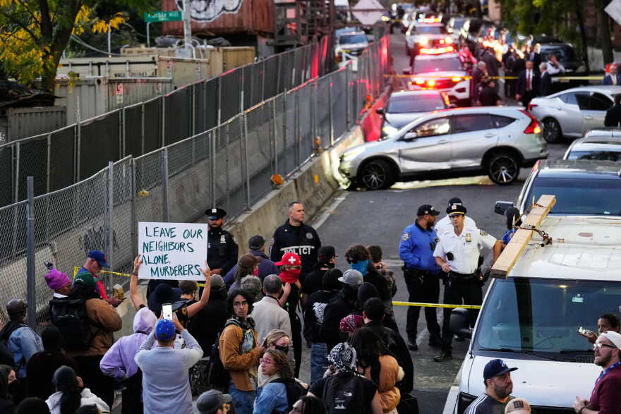 People gather at the scene of a shooting as law enforcement work the area Thursday, Oct. 8, 2026, in New York.