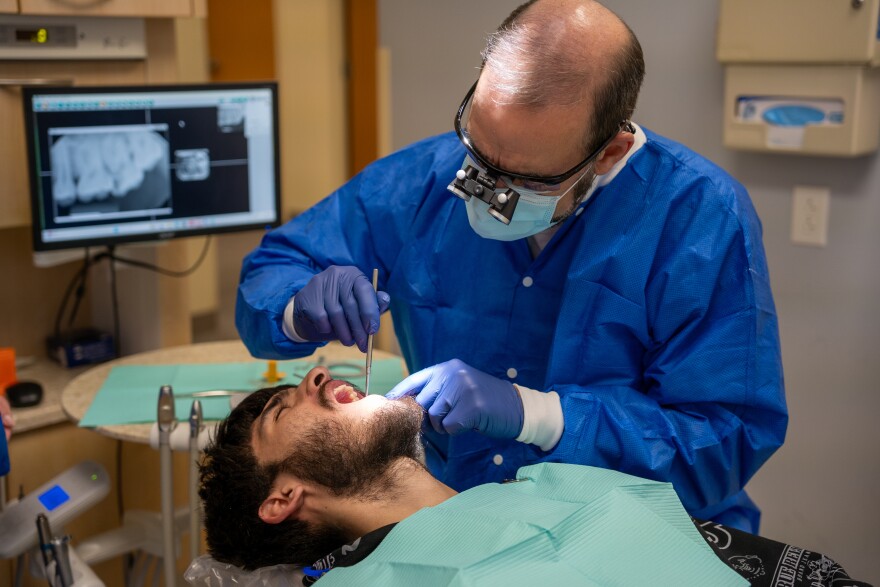 A dentist examines a cavity inside the mouth of a patient in Lorain County, Ohio.