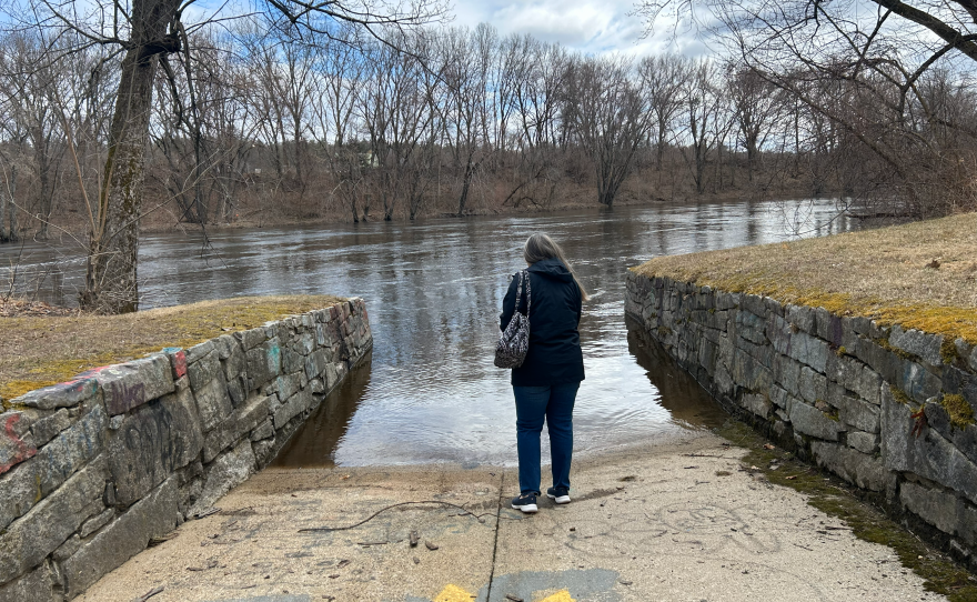 Laurene Allen looks at the Merrimack River in Merrimack, N.H.
