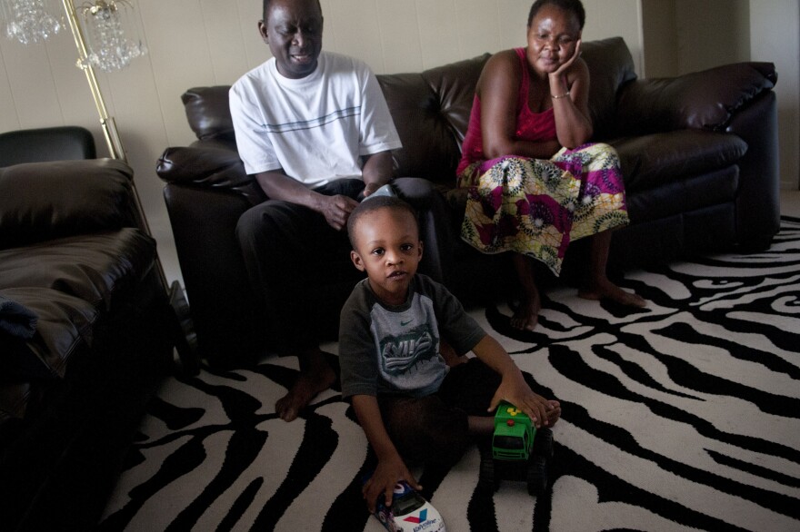 Fafaneva Phillip Avudufu (left) and his wife, Akouavi Davi, with their grandson Joshua, 4, in their apartment in Gaithersburg, Md.