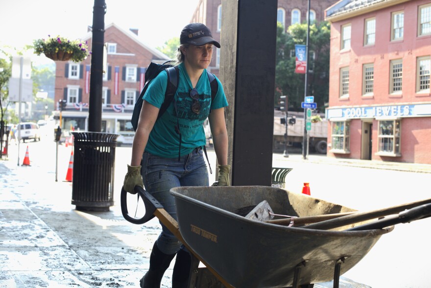 A person pushes a wheelbarrow