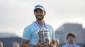 Wyndham Clark holds the holds the trophy after winning the U.S. Open golf tournament at Los Angeles Country Club on Sunday, June 18, 2023, in Los Angeles. (AP Photo/George Walker IV)