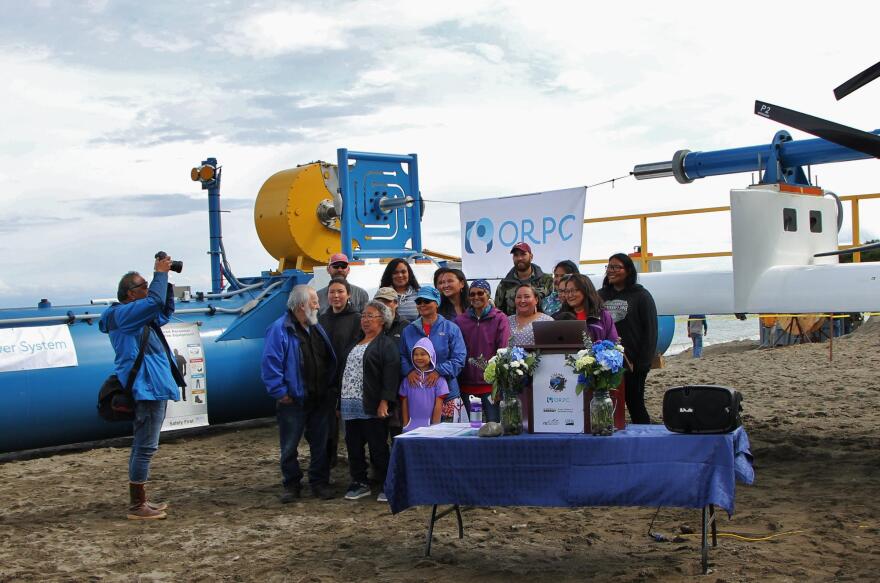 Residents of Igiugig pose in front of the RivGen system at the launch ceremony, July 16, 2019. (Photo by Isabelle Ross, KDLG - Dillingham)