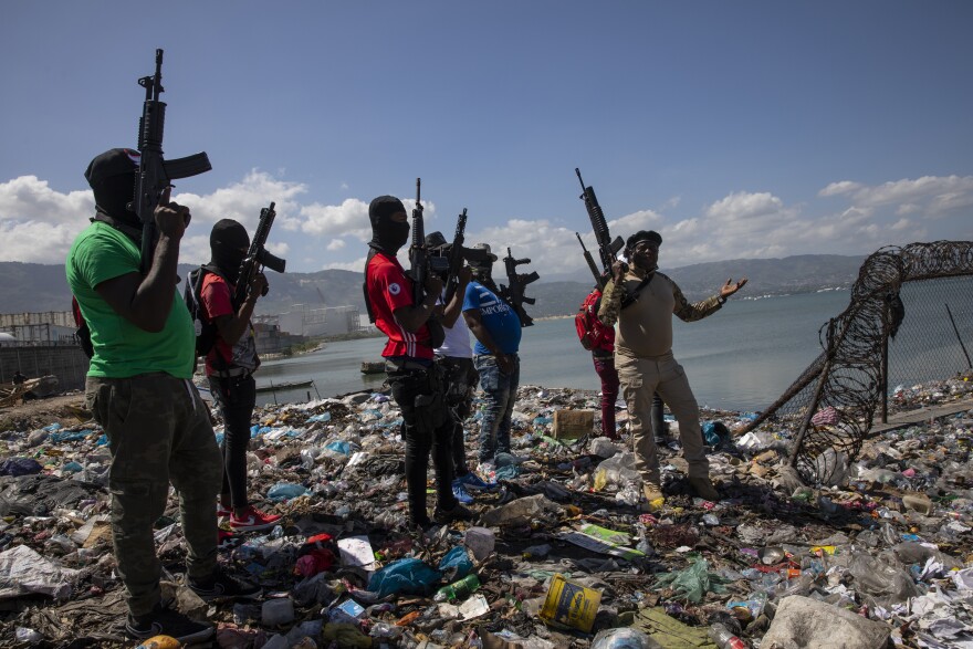 RULE OF LAW SUNK Haitian gang members brandish the smuggled military-style weapons that have helped them gain control of much of the country