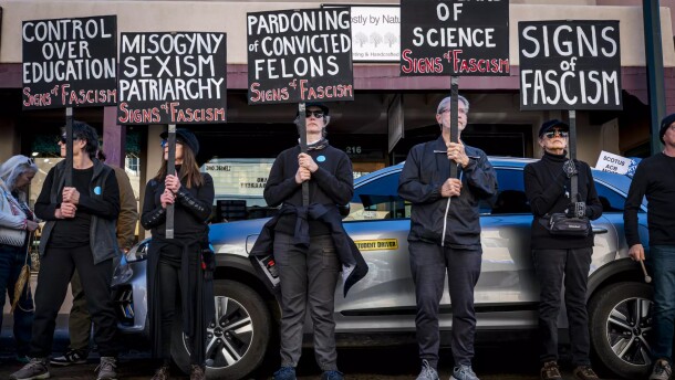 People hold signs protesting Supreme Court Justice Amy Coney Barrett's appearance at the Lensic Performing Arts Center on Sunday.