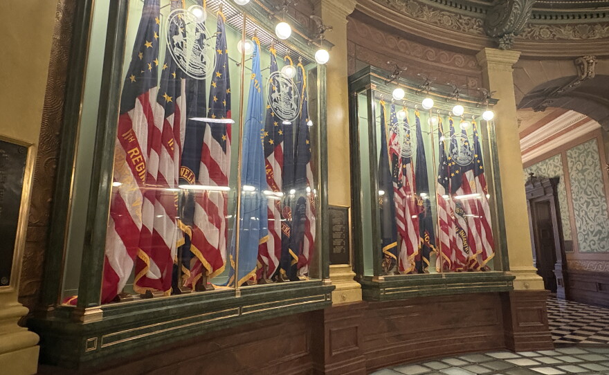 A glass case with flags in 