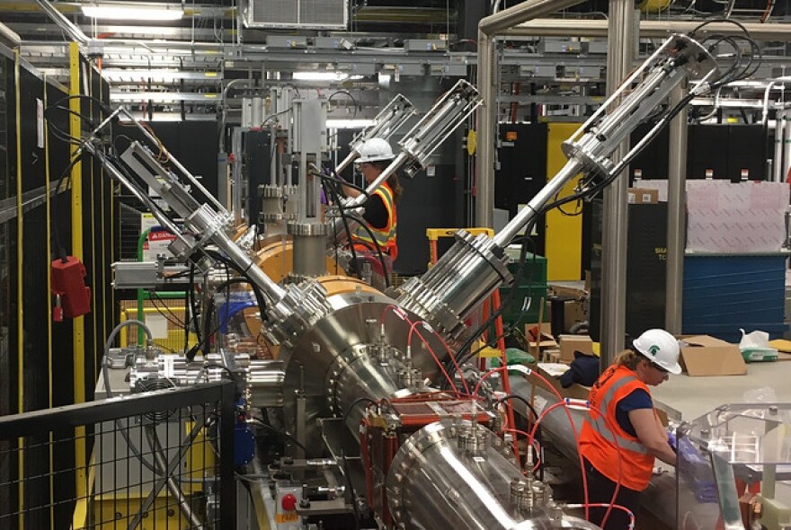 Workers prepare Michigan State University's Facility for Rare Isotope Beams.
