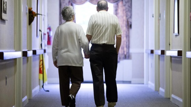 An elderly couple walks down a hallway (AP Photo/Matt Rourke, File)