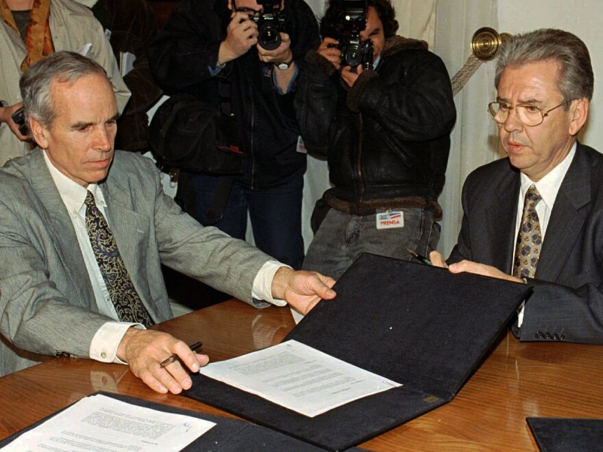 Douglas Tompkins (left) and Juan Villarzu, chief of staff of the Chilean president, with the text of a 1997 agreement permitting the development of a huge nature sanctuary in southern Chile.