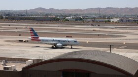 A white, red and blue jet sits on the tarmac