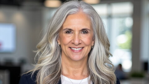 Professional portrait of a woman in a navy blue blazer.