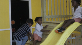 Kids play on the indoor playset on opening day of Busy Bees Playhouse.