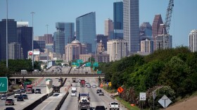 FILE - Traffic moves along Interstate 10 near downtown Houston, April 30, 2020.