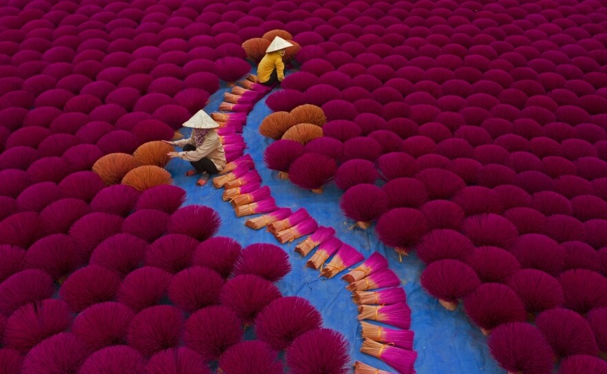 Workers gather incense sticks into bundles at a village near Hanoi, Vietnam.<strong> </strong>