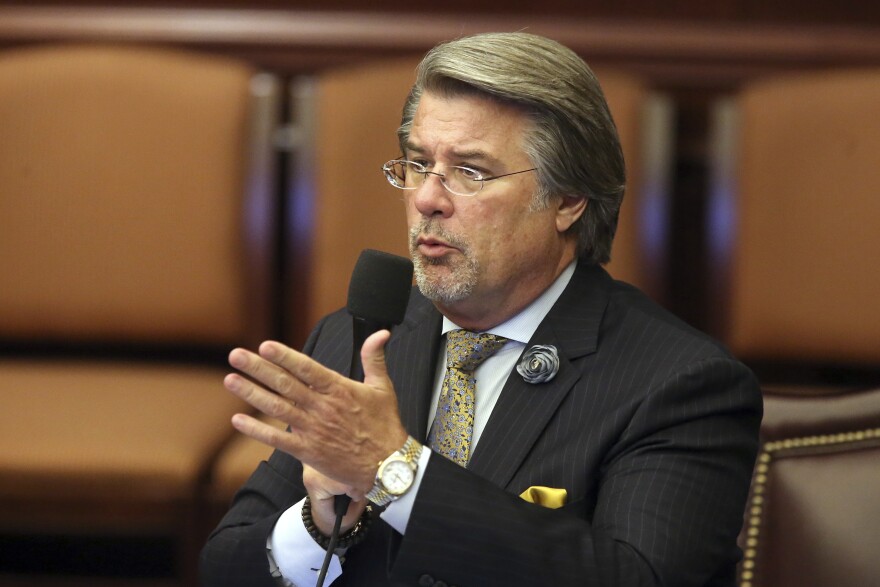 A male politician speaks at a podium