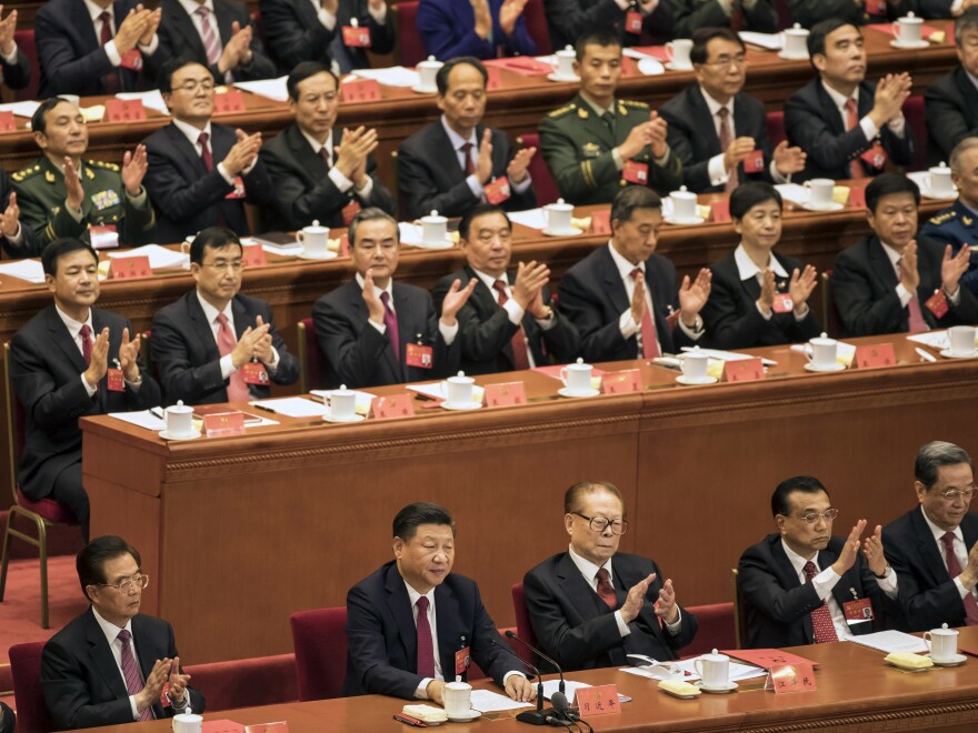 Applause rained down for China's President Xi Jinping on Tuesday, as the Communist Party of China adopted his "thought." Xi (bottom center) was flanked by former presidents (from left) Hu Jintao and Jiang Zemin, along with Premier Li Keqiang.