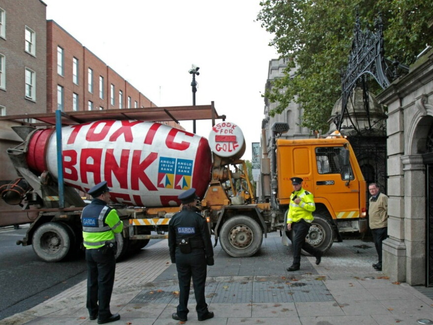 Irish police officers look at a cement mixer that was driven into the gate of Ireland's Parliament building in Dublin.