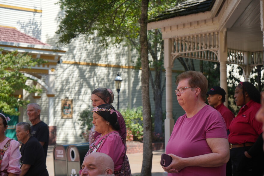 Visitors and employees mourn Dolly Parton during a moment of silence at Dollywood on August 26, 2026.