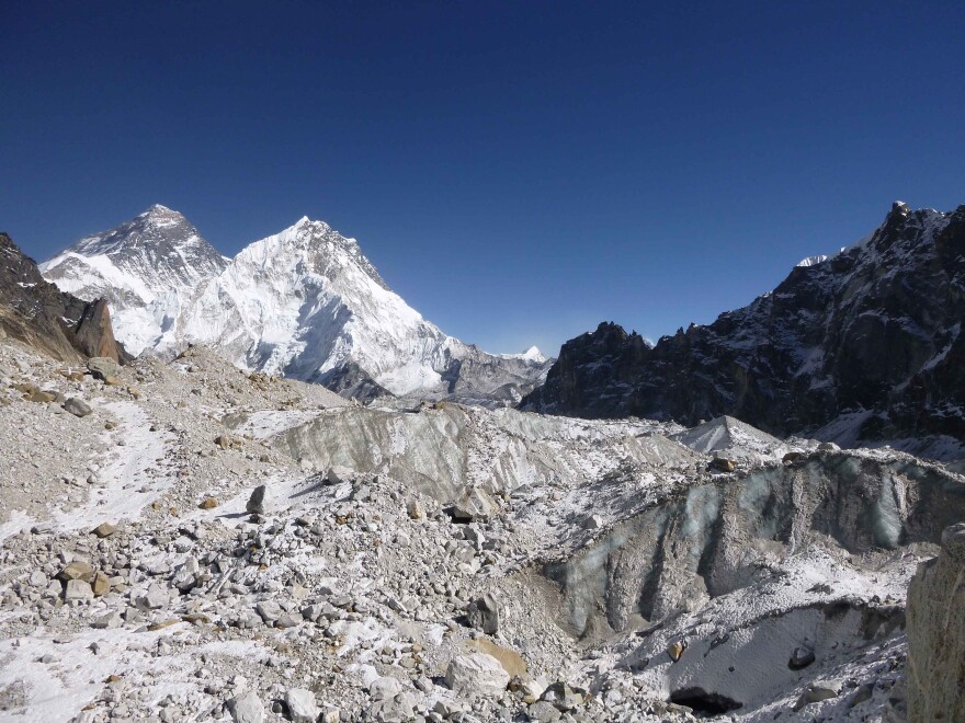 A view of Changri Nup, a typical debris-covered glacier in the Everest region, highlights the glacier's complex surface characteristics, including patches of rock debris and exposed ice cliffs.