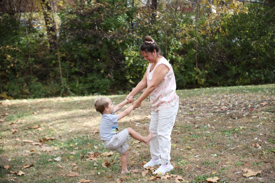 Esther Reddish-Hanner and her son, Alex, play in their backyard in De Soto.