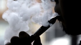 In this April 23, 2014 file photo, a man smokes an electronic cigarette in Chicago.  (Nam Y. Huh/AP)