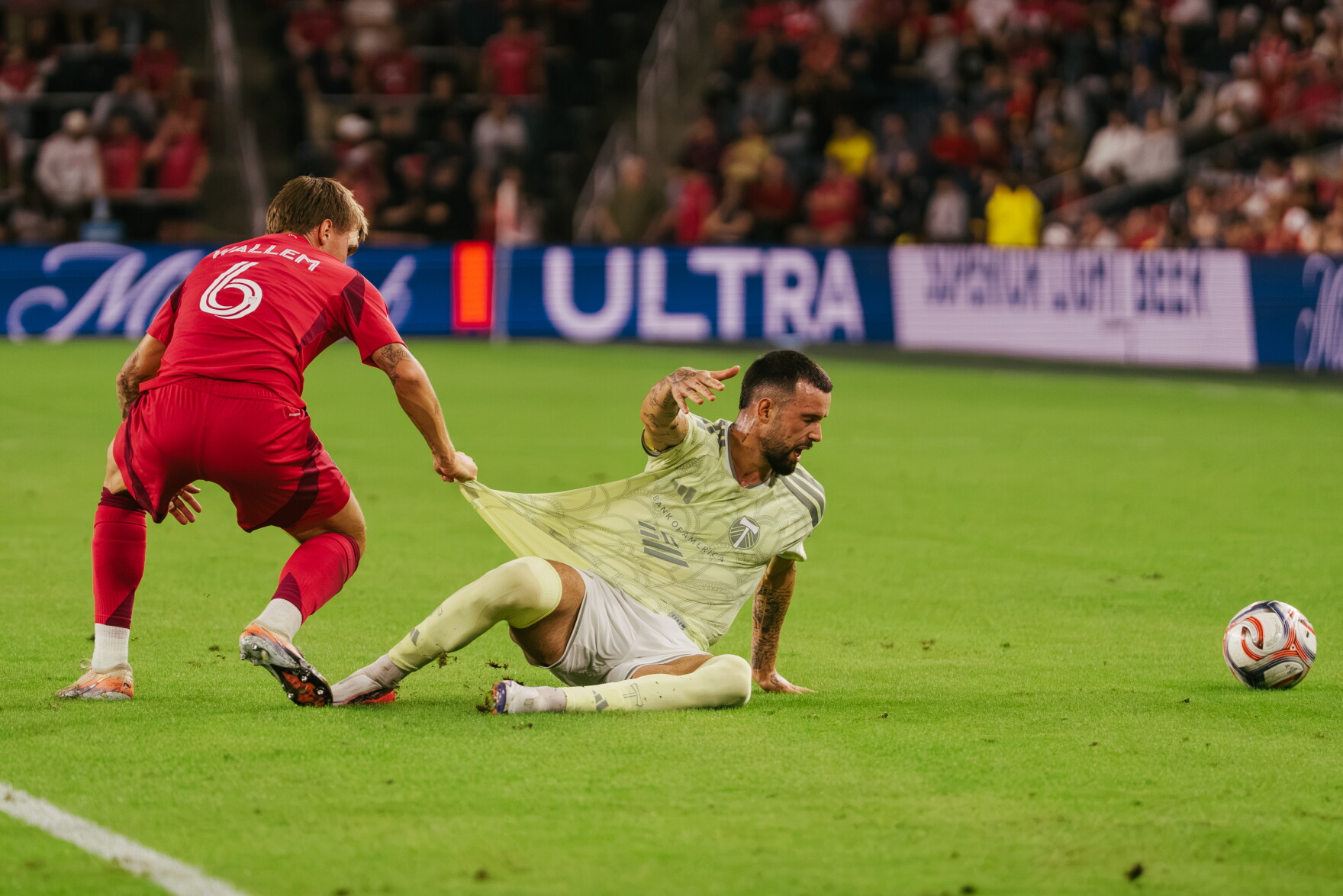 St. Louis City SC midfielder Conrad Wallem (#6) pulls the jersey of Portland Timbers forward Kristoffer Velde (#99) as he falls to the turf at Energizer Park on Wednesday, Oct. 28, 2026, in St. Louis’ Downtown West neighborhood.