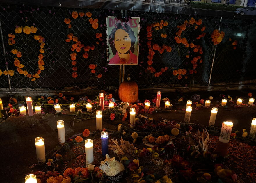 Candles placed at a vigil for late activist Dolores Huerta