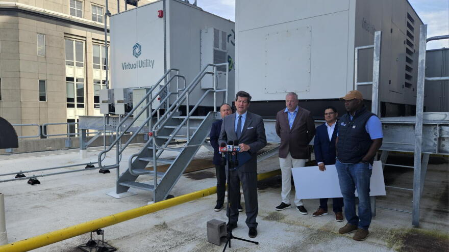 Erie County Executive Mark Poloncarz, front, stands on the roof of the Rath Building and describes the importance of new building upgrades.