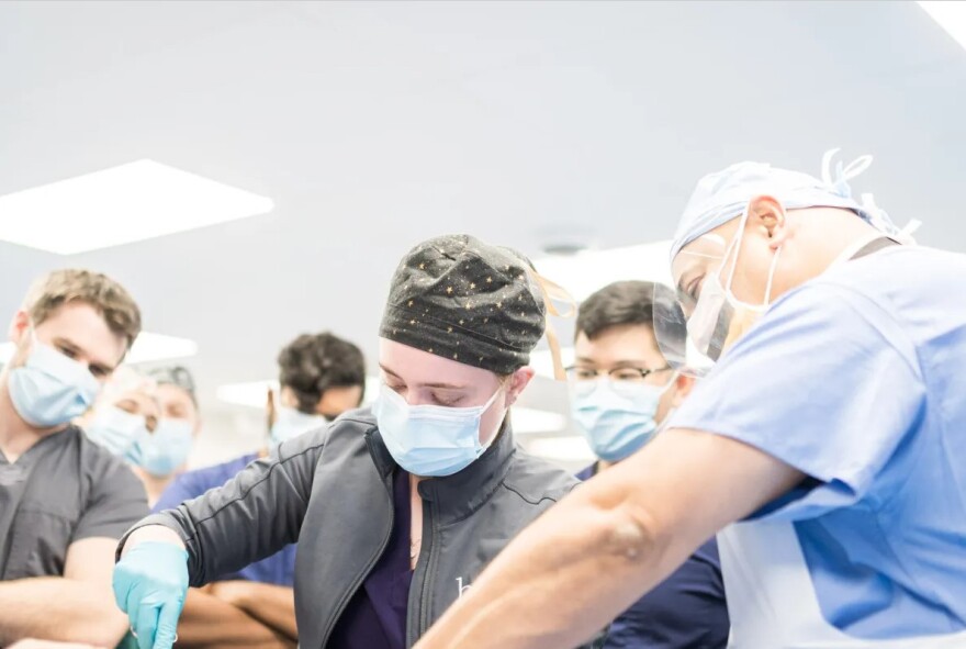 John Peter Smith Hospital trauma surgeon Dr. Rajesh R. Gandhi, now retired, guides a student's cut into a cadaver during anatomy lab at the University of North Texas Health Science Center.