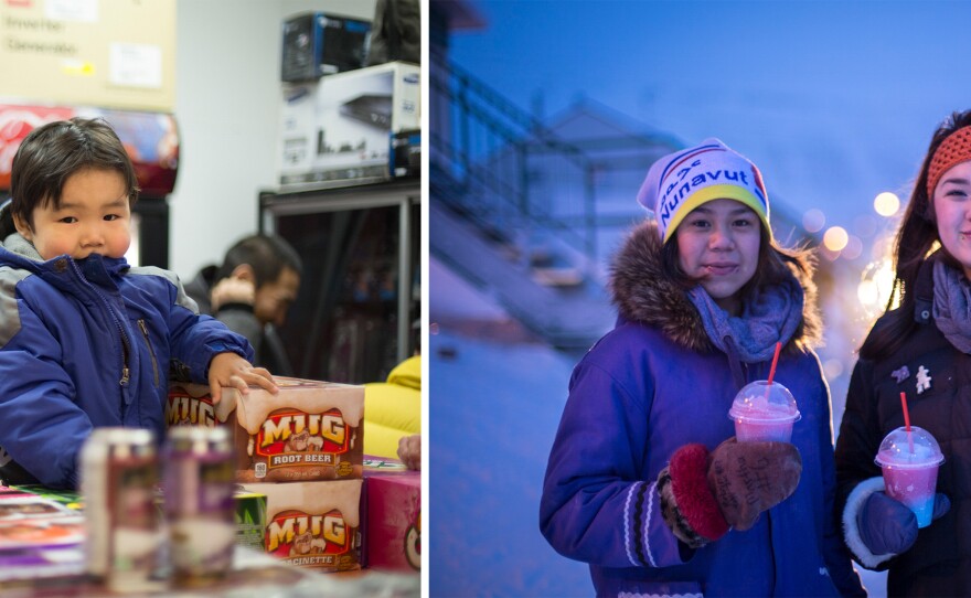 While his parents shop for groceries, Ulluria Ejangiaq climbs on cases of soda in a supermarket in Arctic Bay. Although expensive at $2 to $7 per can, soda is exceedingly popular. Most of it is brought in once or twice a summer by cargo ship when the sea ice melts. Right: As the temperature hovers around 50 degree below zero, Apitah Iqaqrialu and Leetia Kalluk enjoy a frozen slushie.
