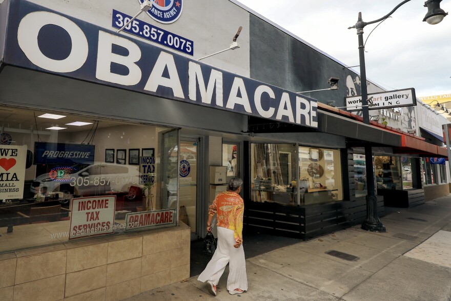 FILE: An Obamacare sign is displayed outside an insurance agency on November 12, 2025 in Miami, Florida. House Democrats are said to be looking at steps to force a vote on extending the expiring Affordable Care Act tax credits after Republicans did not address the issue as part of a deal to reopen the federal government.