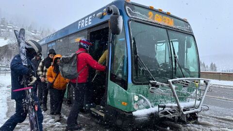 Skiers board a Park City Transit bus at Deer Valley's Snow Park base.